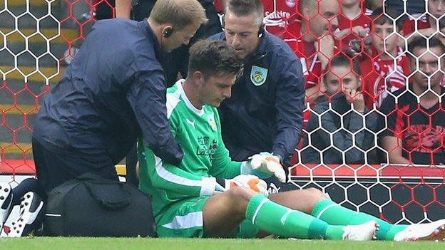 Nick Pope receives treatment after being injured against Aberdeen