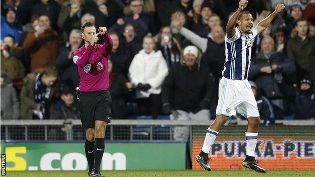 Referee Mark Clattenburg pointed to his watch to highlight Gareth McAuley's header had just crossed the line