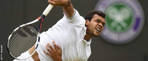 Jo-Wilfried Tsonga serves against Richard Gasquet at Wimbledon