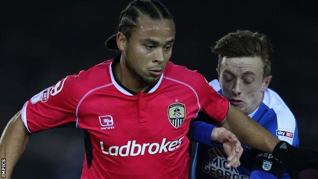 Curtis Thompson holds off an opponent during a Notts County match