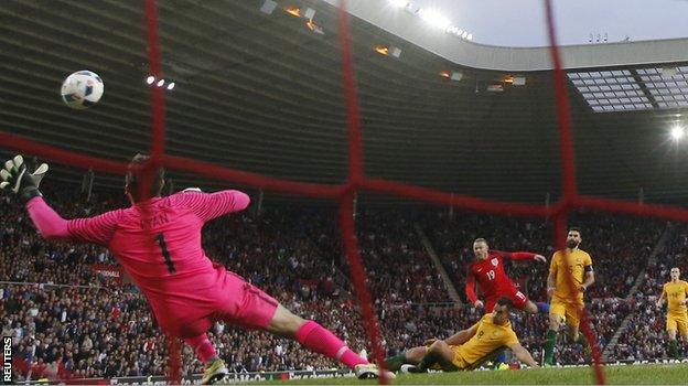 England forward Wayne Rooney scores against Australia