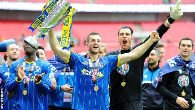 Jon Meades (centre) celebrates AFC Wimbledon's victory in the League Two play-off final in 2016