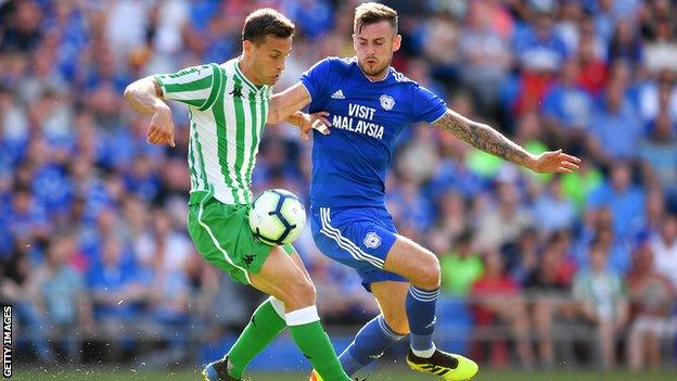 Sergio Canales of Real Betis holds off Joe Ralls of Cardiff City during the Pre-Season Friendly match between Cardiff City and Real Betis at Cardiff City Stadium