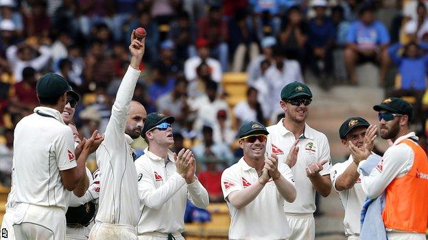 Australia spinner Nathan Lyon holds the ball up after taking his fifth wicket