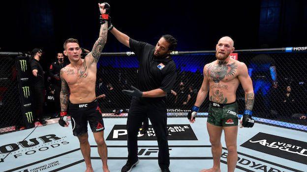 Dustin Poirier has his hand raised as he is declared winner of his second fight with Conor McGregor