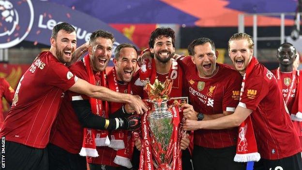 Andy Lonergan and Liverpool's goalkeepers and staff lift the Premier League trophy