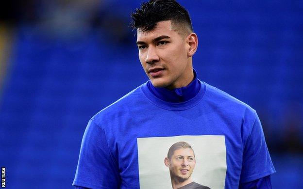 Cardiff goalkeeper Neil Etheridge displays the t-shirt showing Sala's face that players wore to warm up