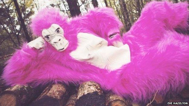 Eve dressed as a bright pink gorilla