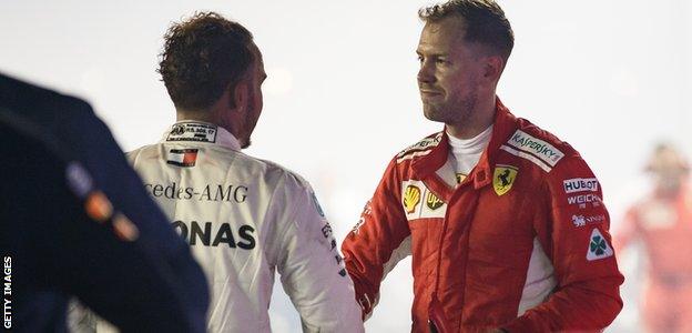 Sebastian Vettel shakes Lewis Hamilton's hand after the Singapore Grand Prix