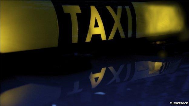 A taxi sign on a car