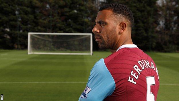 Anton Ferdinand stands on an empty pitch in a West Ham shirt