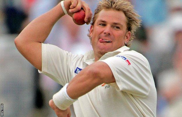 Shane Warne bowls the ball