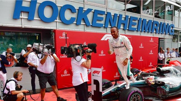 Mercedes driver Lewis Hamilton celebrates winning the German Grand Prix