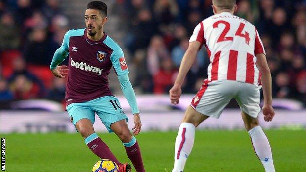 Manuel Lanzini (left) runs with the ball