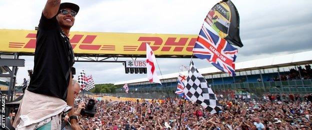 Lewis Hamilton waves to the fans after winning the British Grand Prix