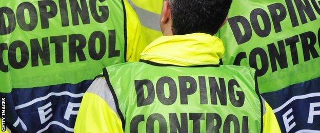 Members of UEFA's doping control look on during the final football match of the UEFA Europa League Fulham FC vs Aletico Madrid in Hamburg, northern Germany on May 12, 2010