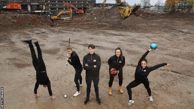 Team England athletes Dominick Cunningham (gymnast), Lily Owsley (hockey), Tom Hamer (swimmer), Siobhan Prior (basketball), Mimi Cesar (gymnast) pose for a photo on proposed site for the 2022 Commonwealth Games athletes' village