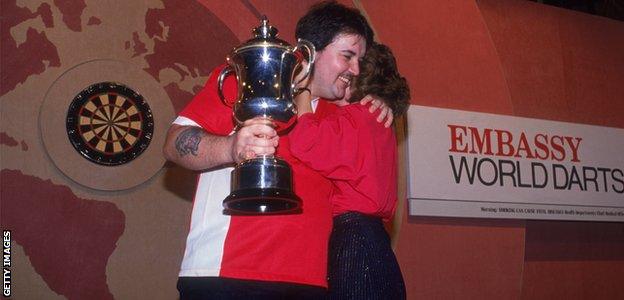 Phil Taylor (left) competing in the World Professional Darts Championship at the Lakeside Country Club at Frimley Green in January 1990