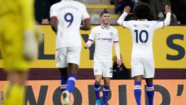 Christian Pulisic celebrates scoring with Willian and Tammy Abraham