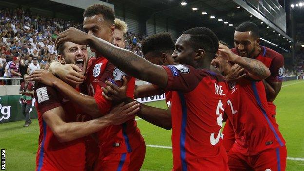 Adam Lallana (left) is congratulated by England team-mates after his winner in Slovakia