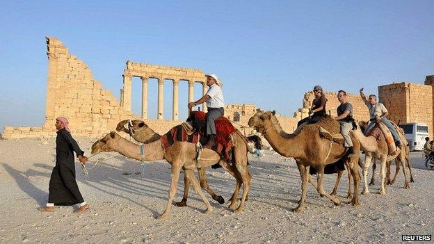 Tourists ride camels in the historical city of Palmyra - 30 September 2010