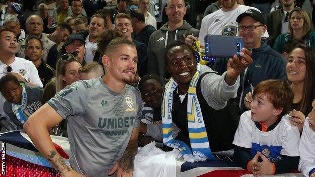 Kalvin Phillips poses for a photo with Leeds fans