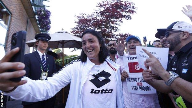 Ons Jabeur takes a selfie with Tunisian fans at Wimbledon