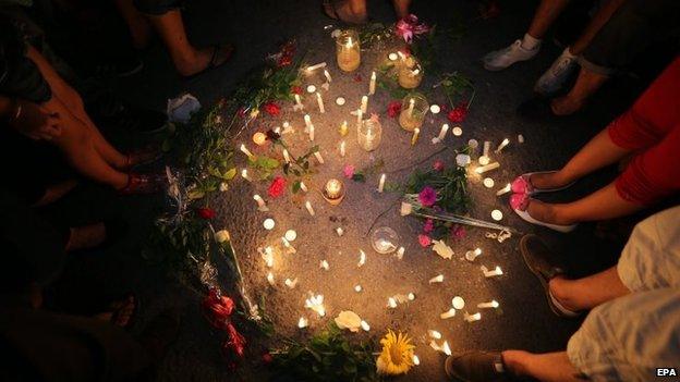 People gather for a candle light rally in solidarity with the victims of a deadly attack on the Imperial Marhaba hotel, in Sousse