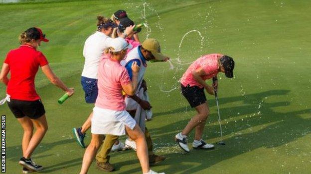 Becky Morgan is covered in champagne