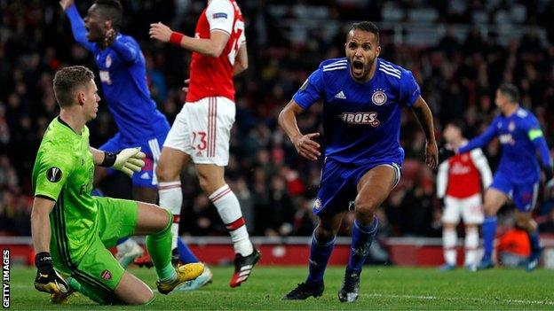 Olympiakos celebrate their last-minute-of-extra-time winner against Arsenal in the last 32 of the Europa League