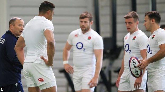 Eddie Jones (left) and England players at training