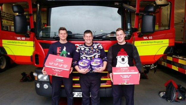 Three firefighters in Christmas jumpers