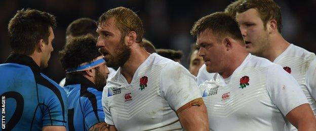 England captain Chris Robshaw and his team-mates walk off the pitch after victory over Uruguay in theri final group game