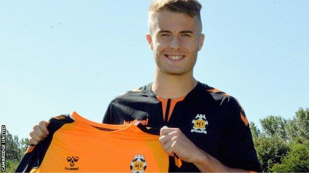 Andrew Dallas poses with a Cambridge shirt