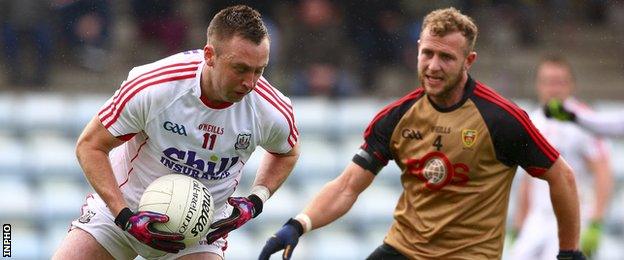 Paul Kerrigan attempts to turn Down's Gerard McGovern in the Division One game at Pairc Ui Rinn