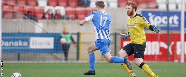 Coleraine's Brad Lyons rounds Cliftonville keeper Conor Devlin as he is about to stroke in the Bannsiders' third goal at Solitude