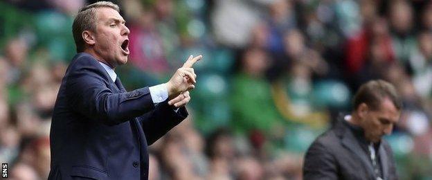 Lee Clark makes a point to his team as Brendan Rodgers makes a note in his notebook