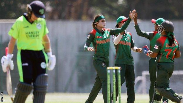 Ireland opener Clare Shillington walks off as Bangladesh celebrate her dismissal in the second T20