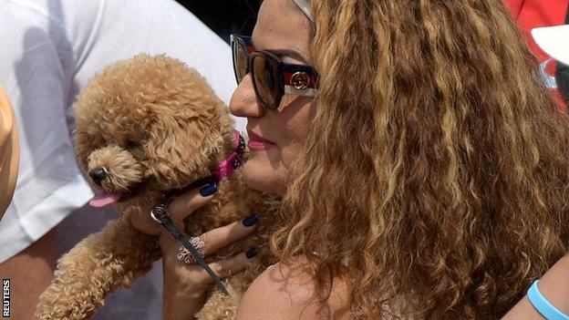 Bianca Andreescu's mum holds her dog Coco