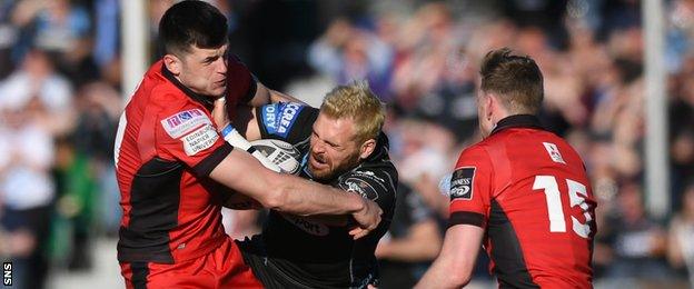 Glasgow Warriors' Sean Lamont is tackled against Edinburgh