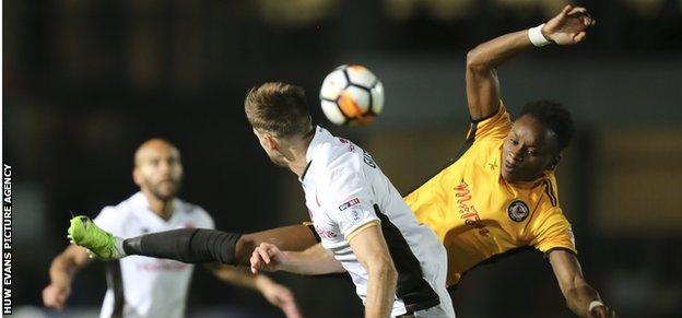 Shawn McCoulsky of Newport County and Jon Guthrie of Walsall compete for the ball