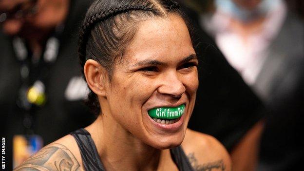 Amanda Nunes shows her mouthguard