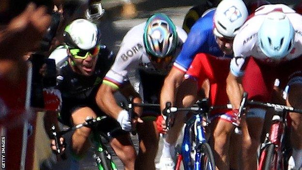 Mark Cavendish (left) hits the barriers after tangling with Peter Sagan