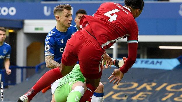 Jordan Pickford recklessly challenges Virgil Van Dijk during the Merseyside derby