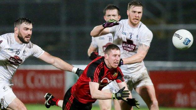 Kildare pair Johnny Byrne and Fergal Conway move in to challenge Mourne forward Joe Murphy