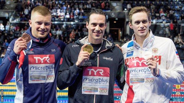 Adam Peaty with his bronze medal in Copenhagen as Fabio Scozzoli celebrates with the gold