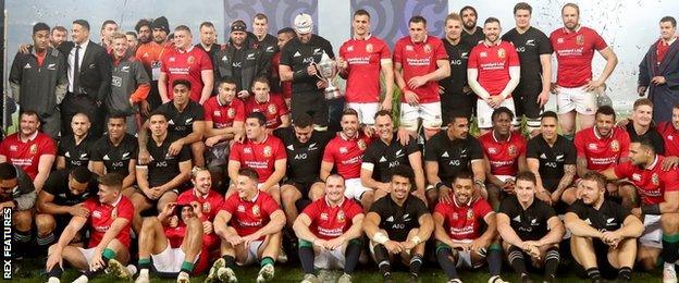 Players from the Lions and New Zealand pose intermingled for the post-match pictuers