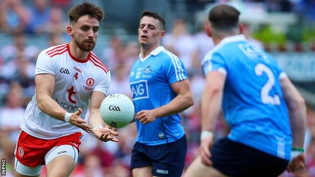 Tyrone's Padraig Hampsey is about to make a hand pass in last year's All-Ireland Final against Dublin