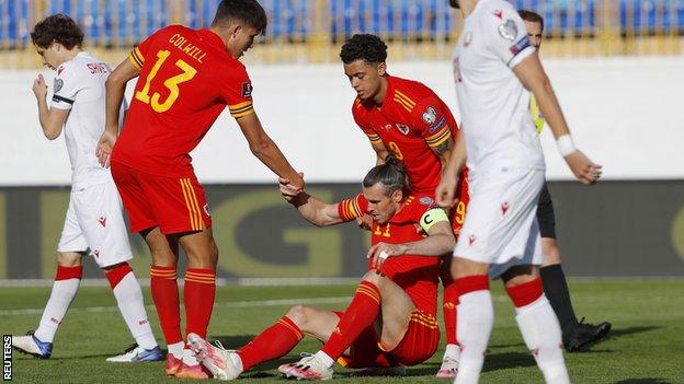 Wales skipper Gareth Bale is helped up after being fouled against Belarus