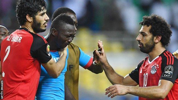 Burkina Faso's goalkeeper Herve Kouakou Koffi (centre) is consoled by Egypt's defender Ali Gabr and forward Mohamed Salah (R) after the 2017 Africa Cup of Nations semi-final in Gabon